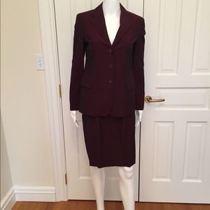 Gabrielle Strennese Bordeaux colored suit.